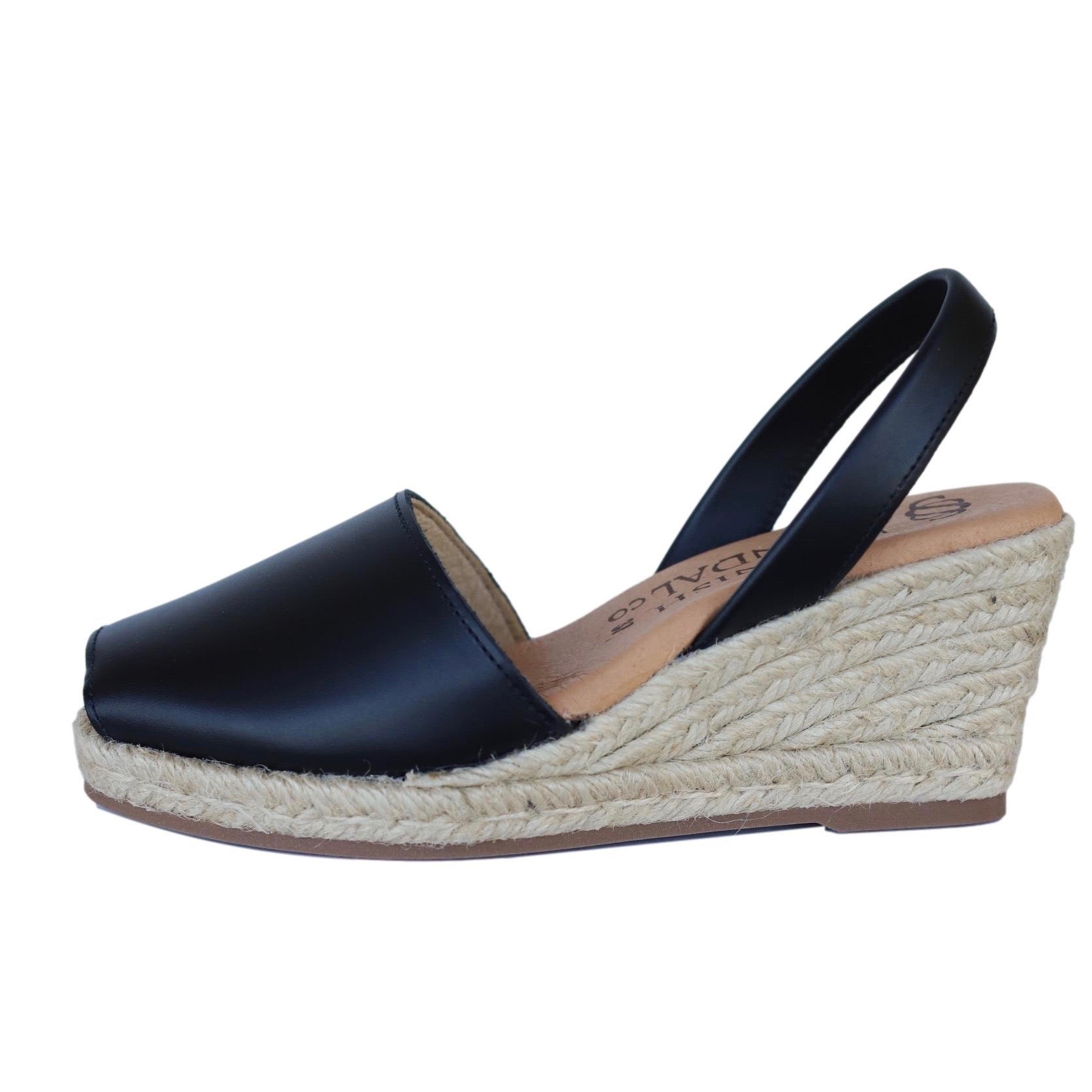 profile view of wedge espadrille sandals in black