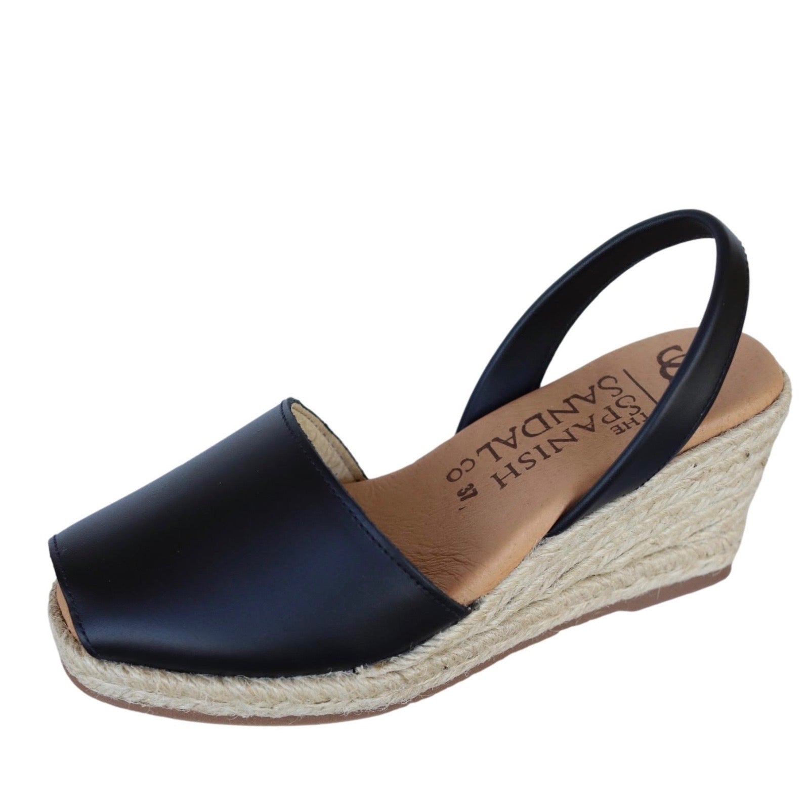 angled view of wedge espadrille sandals in black